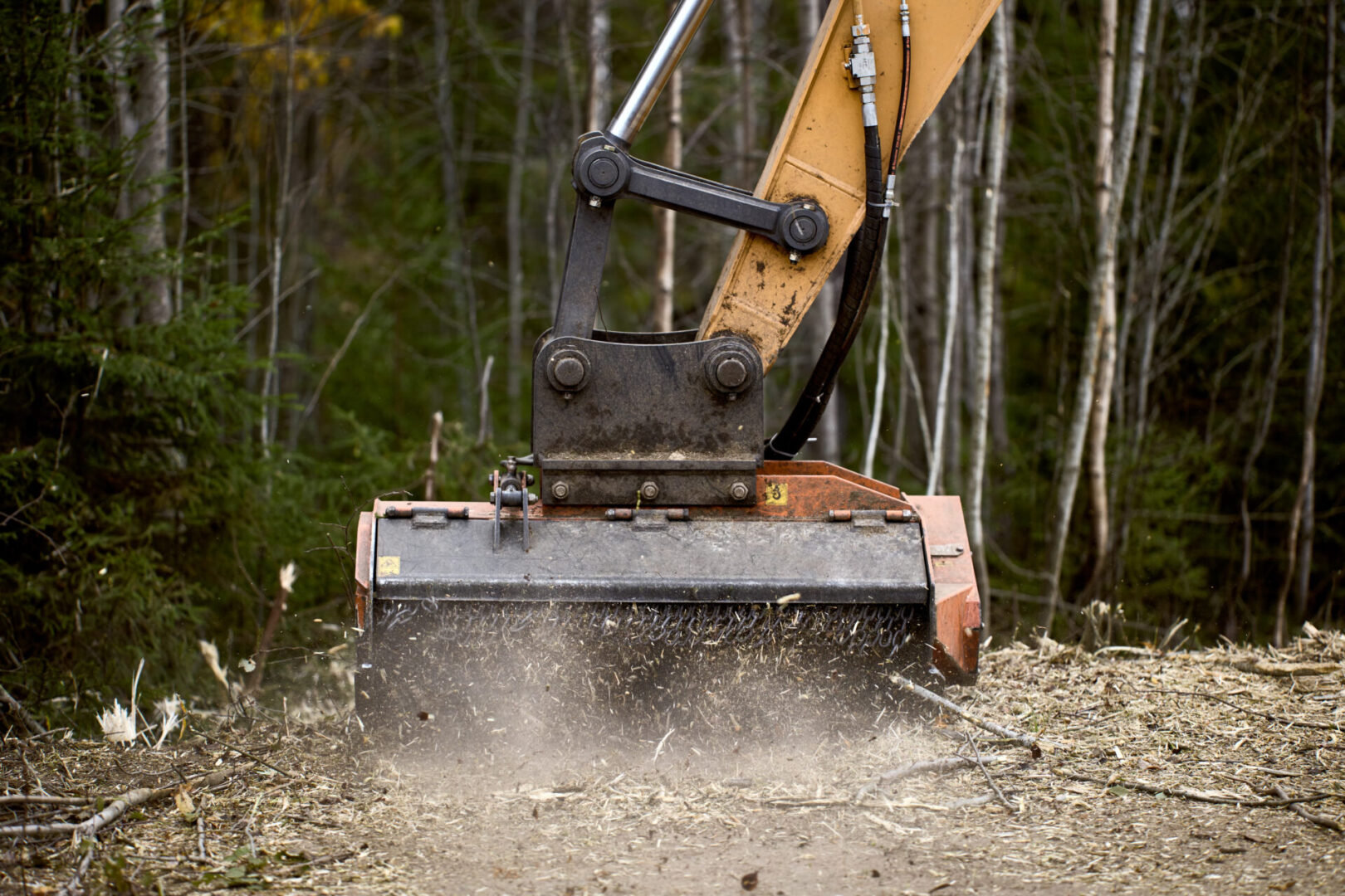 A yellow and black excavator is on the ground